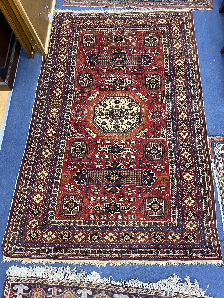 A Caucasian red ground carpet, 204 x 134cm